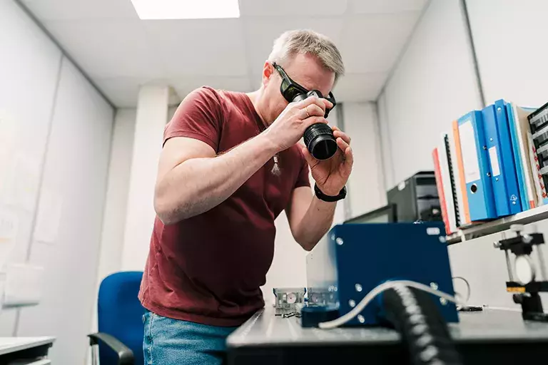 Person seeing through telescope
